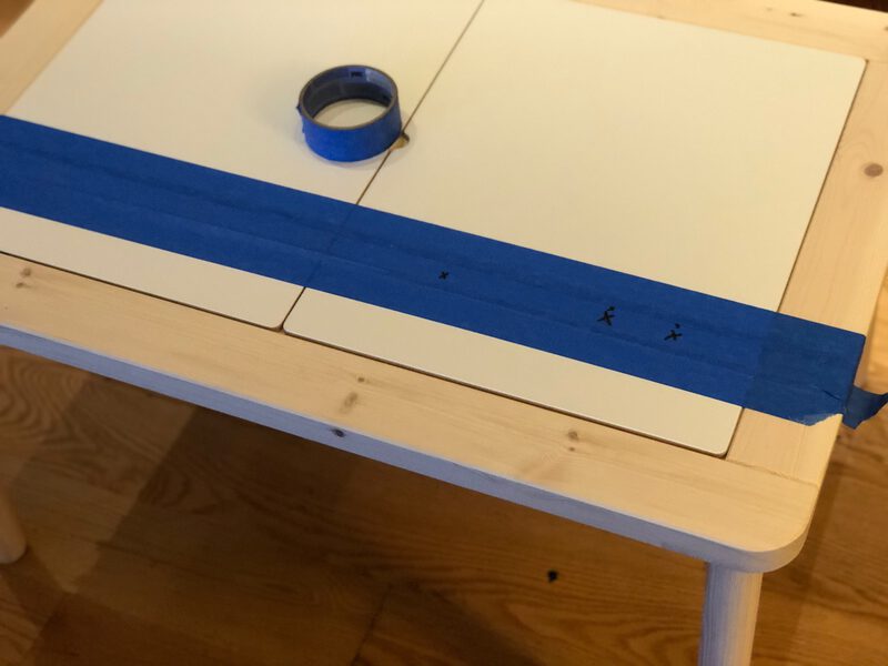 A table with masking tape and drill points